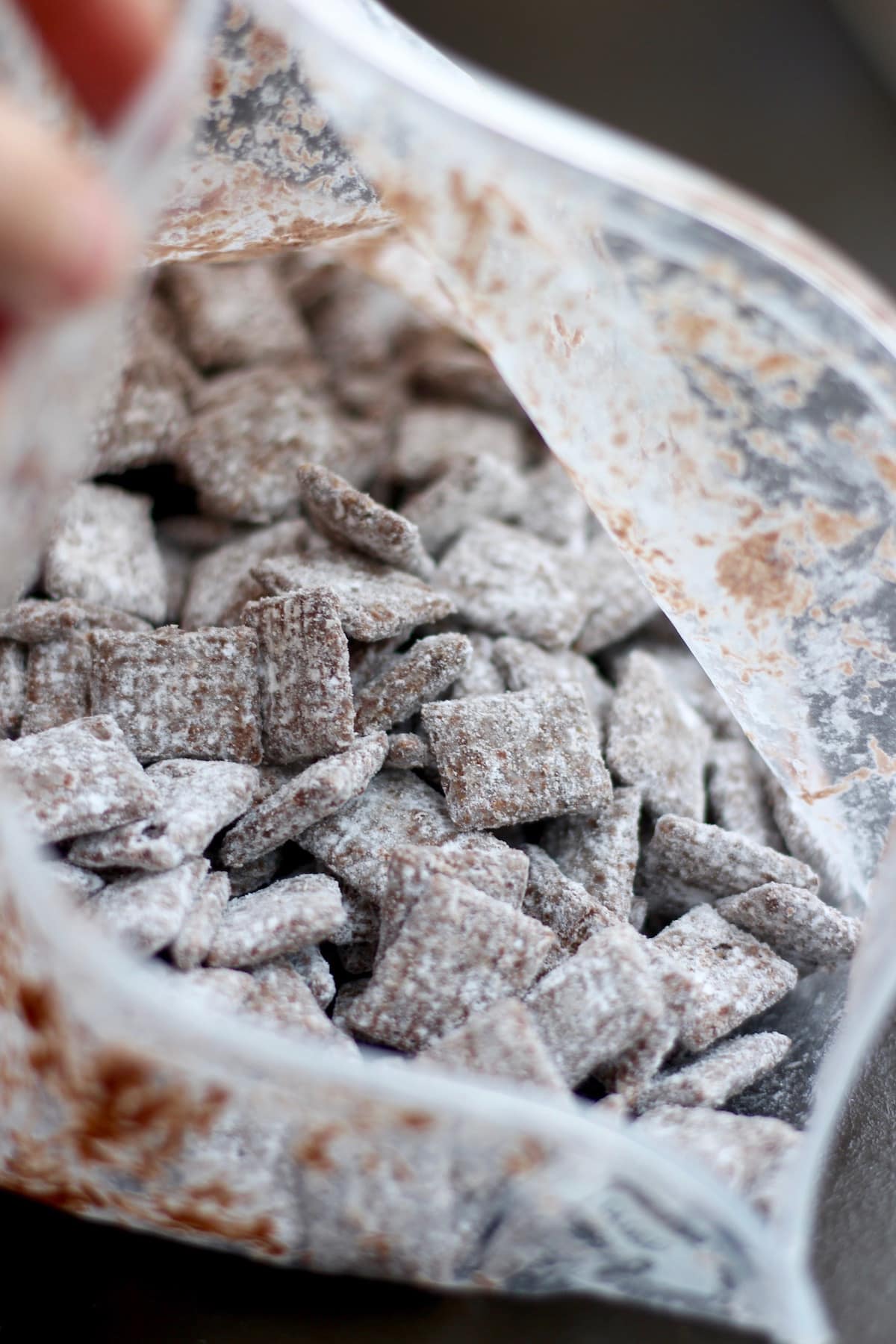 mixing the vegan puppy chow inside a ziplock bag