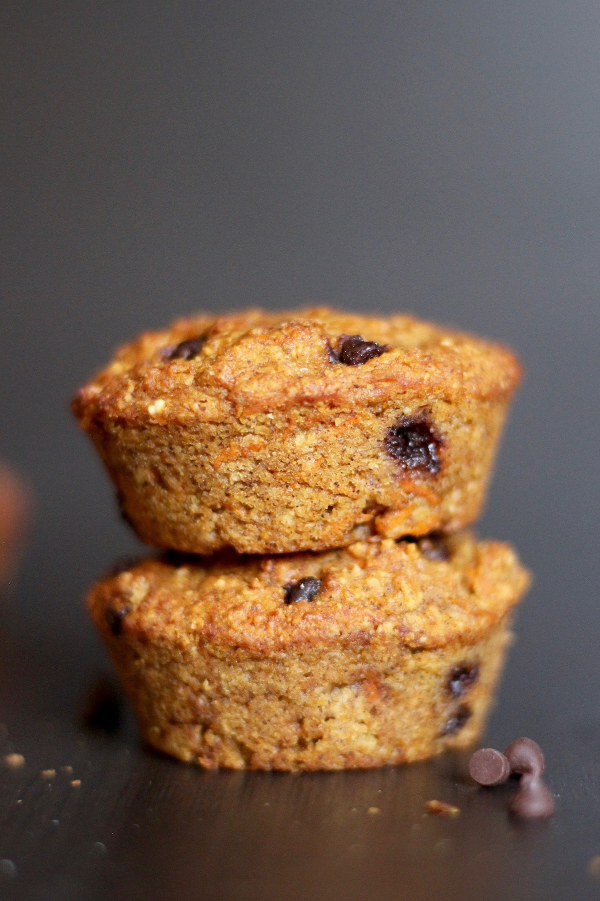 two carrot chocolate chip muffins stacked on each other