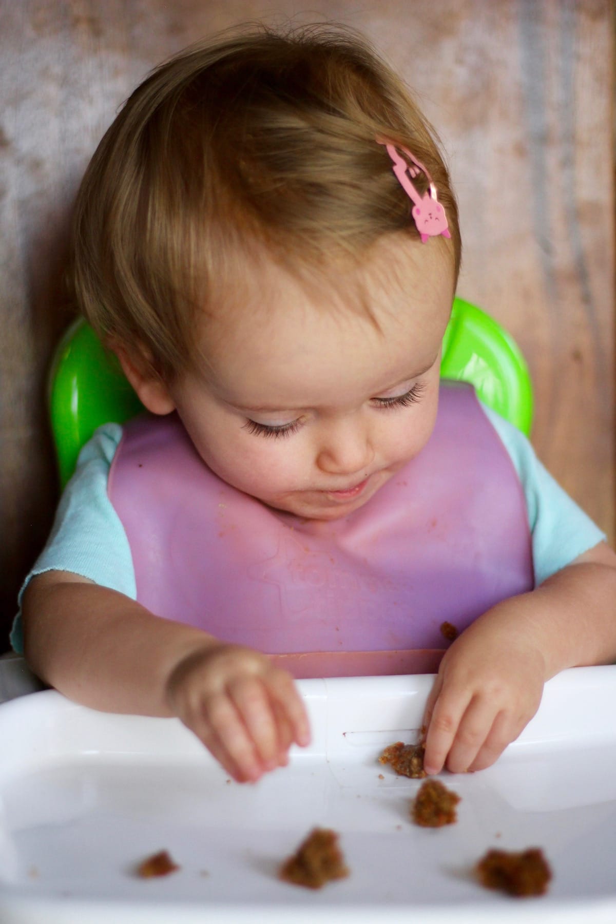 a little girl enjoying a homemade carrot muffin