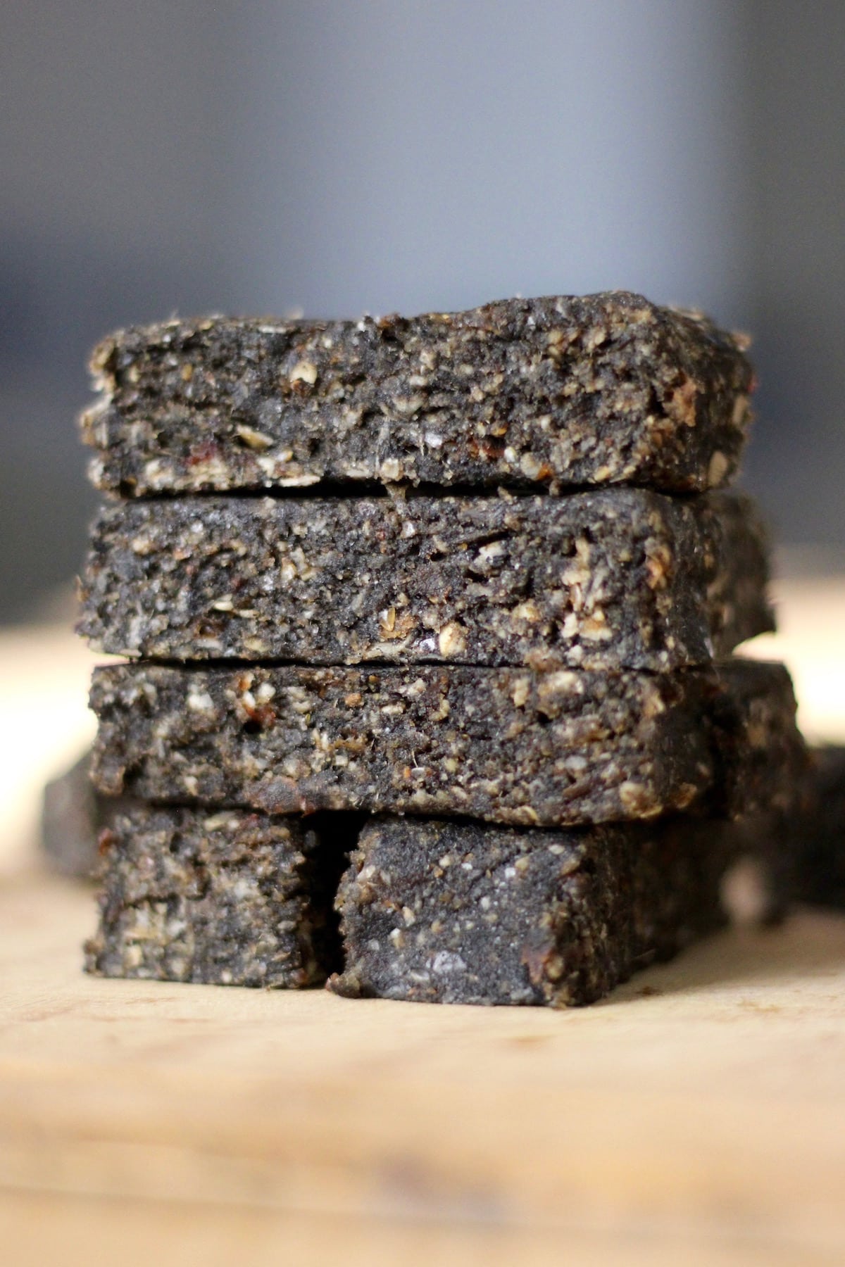 Black Tahini Date Bars stacked on table