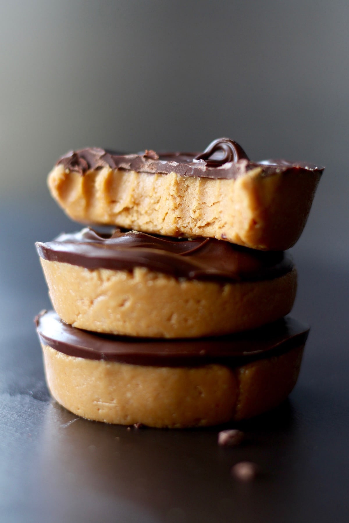 a bite taken out of a vegan peanut butter cup