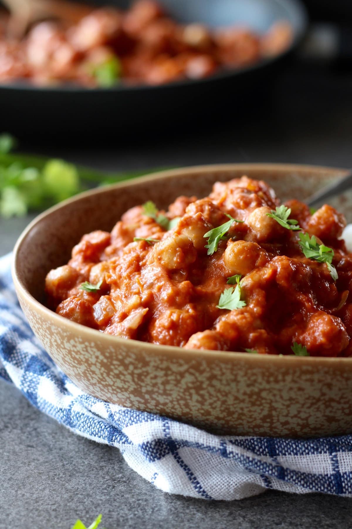 a bowl piled high with tomato rich, creamy chickpea tikka masala
