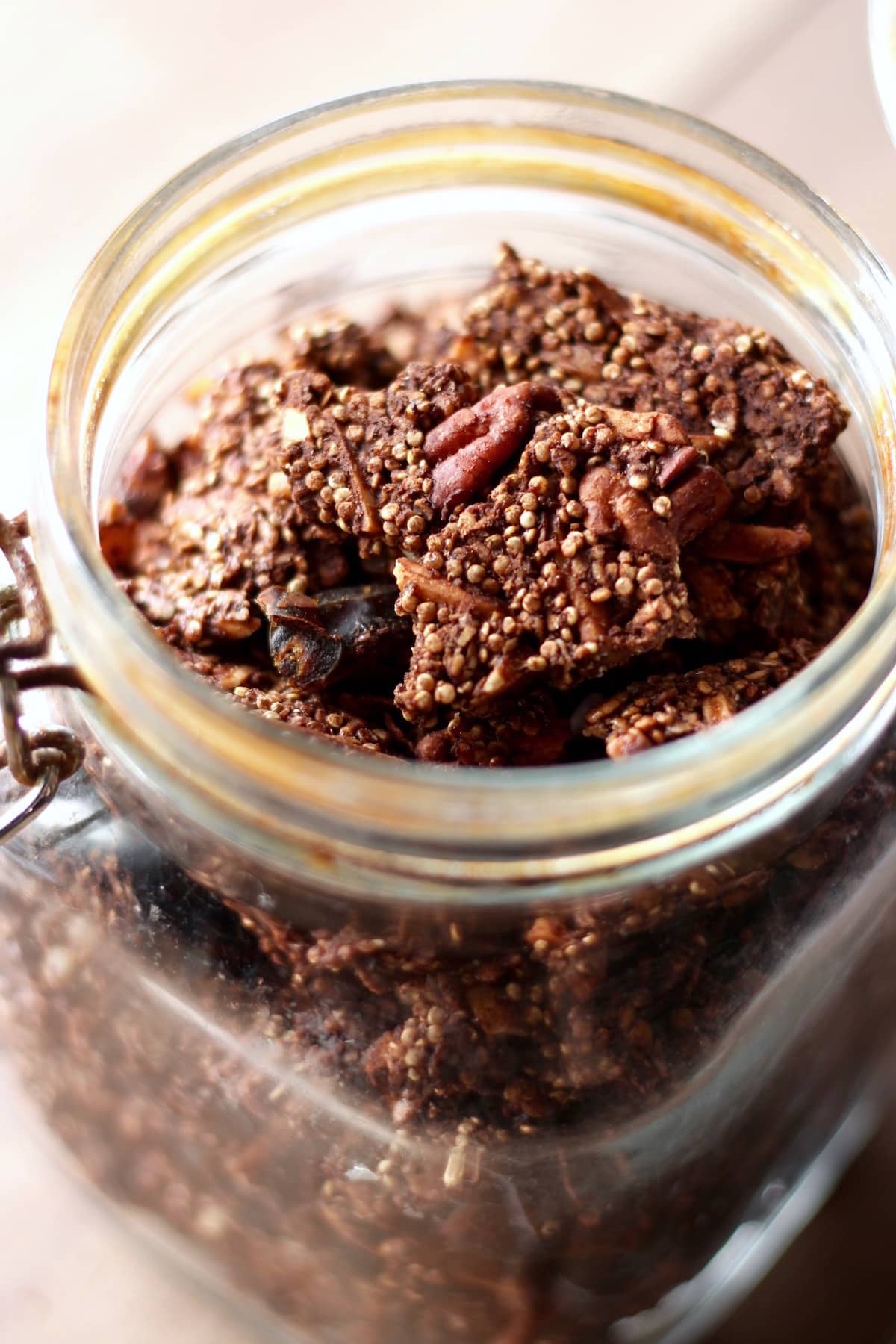 a huge granola cluster in a glass jar