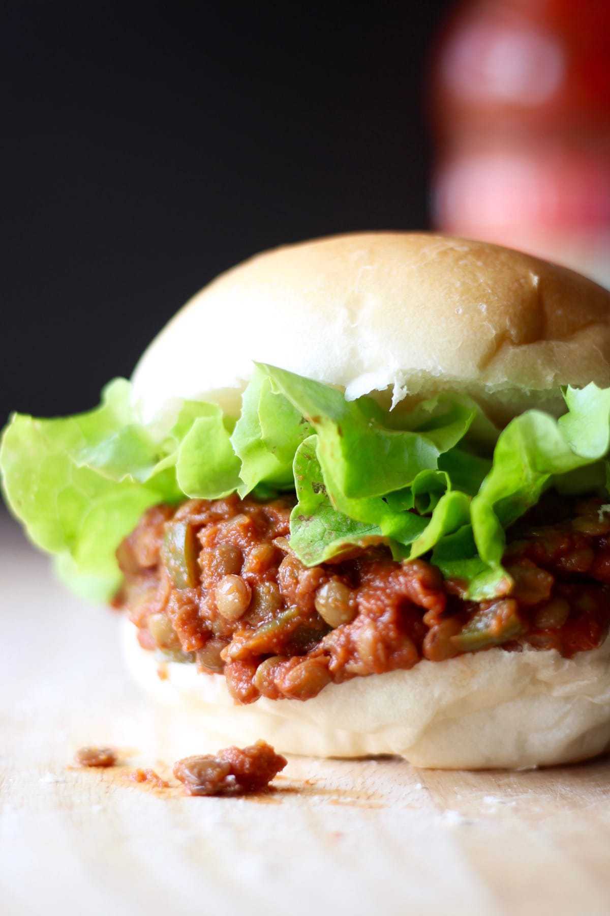 lentil sloppy joes spilling out of a soft hamburger bun