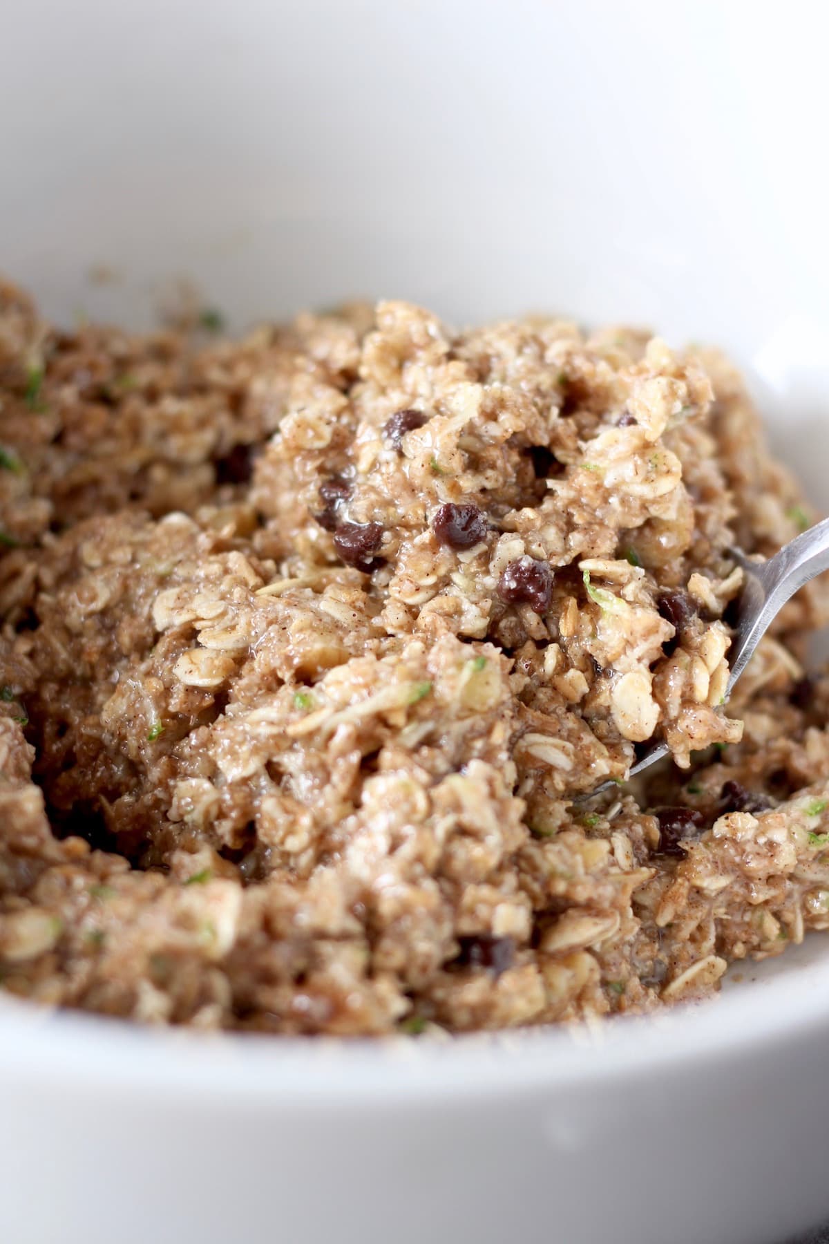 zucchini oatmeal cookie dough being mixed in a bowl