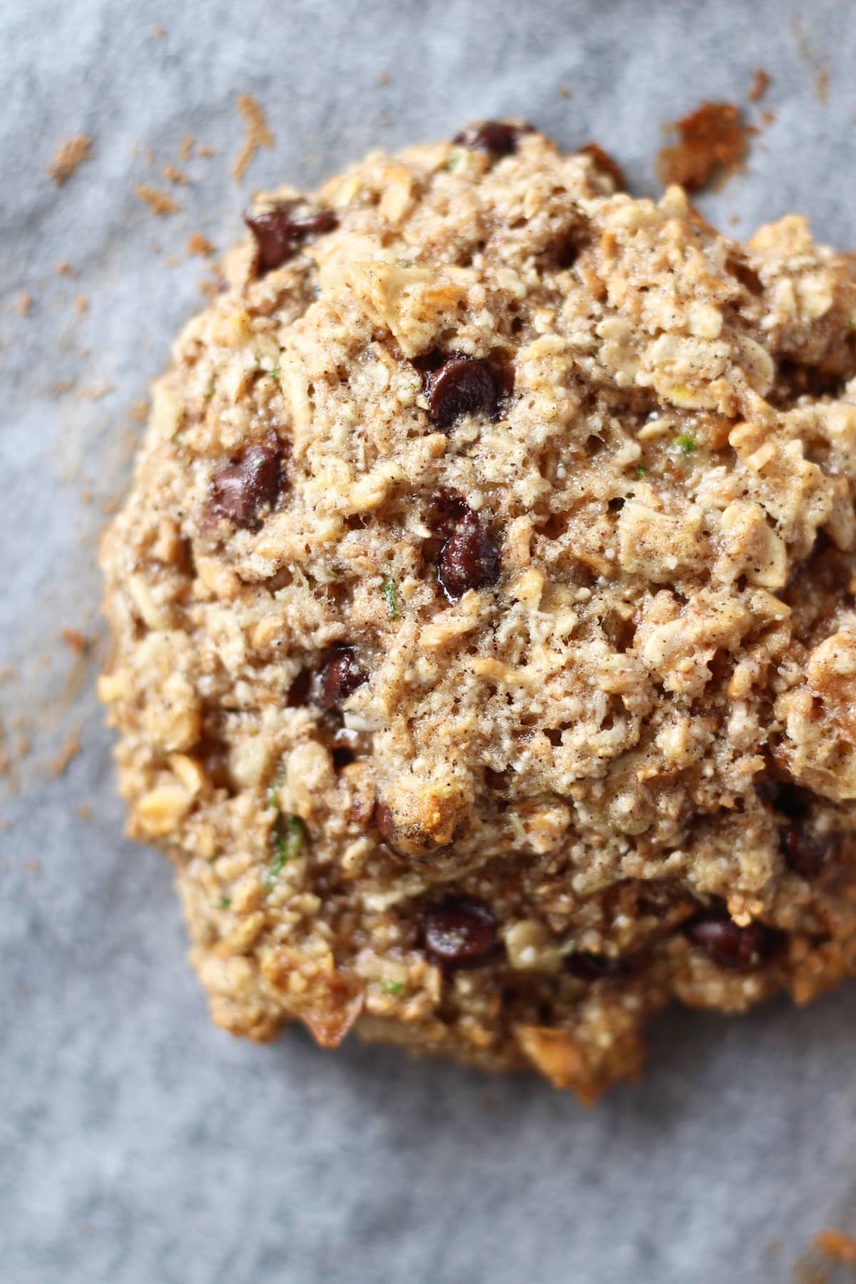 a zucchini and chocolate chip oatmeal cookie on a baking sheet