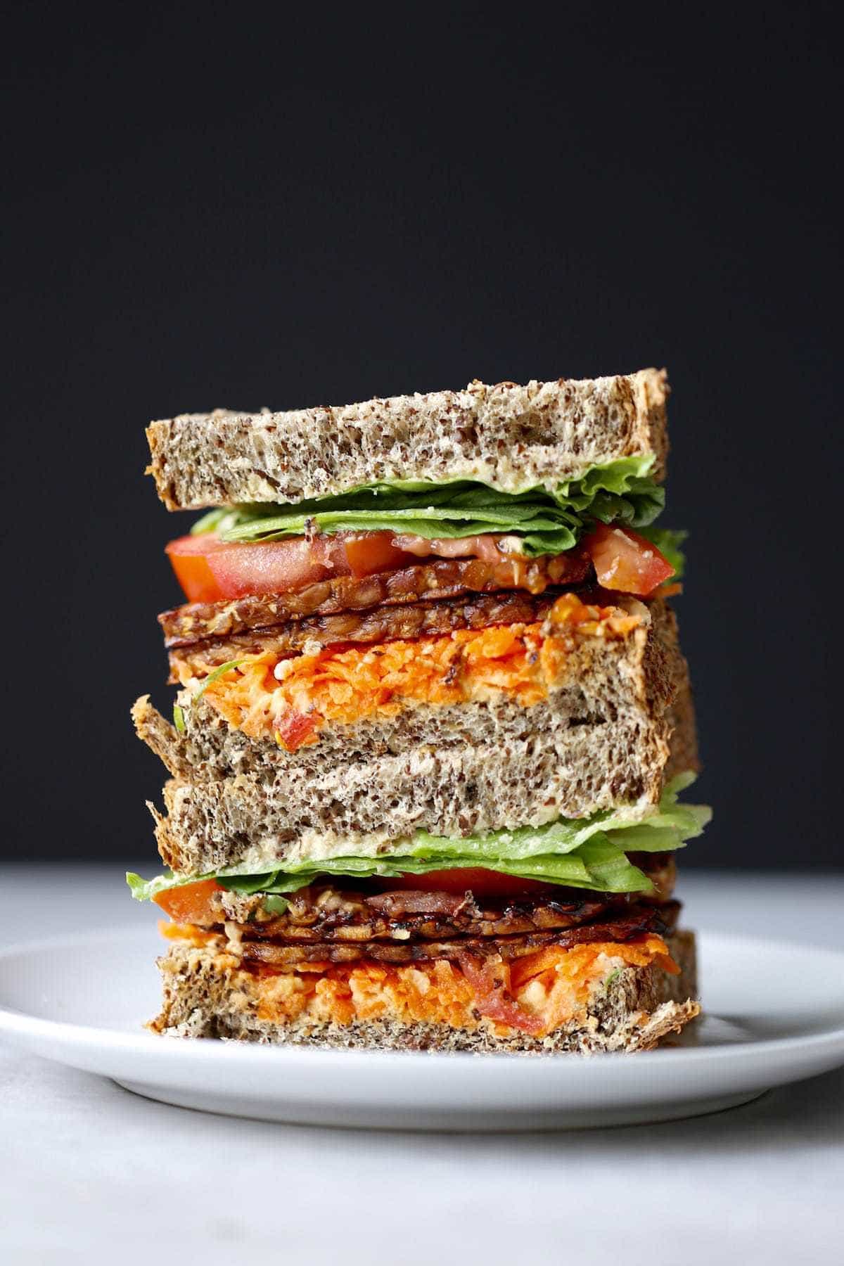 a loaded colorful tempeh bacon sandwich