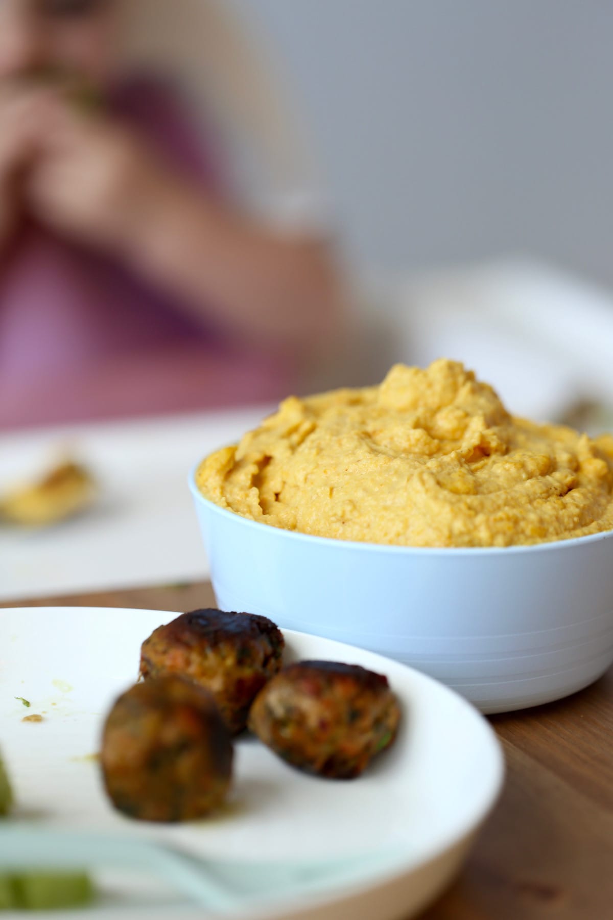 vibrant curried carrot hummus heaped in a bowl