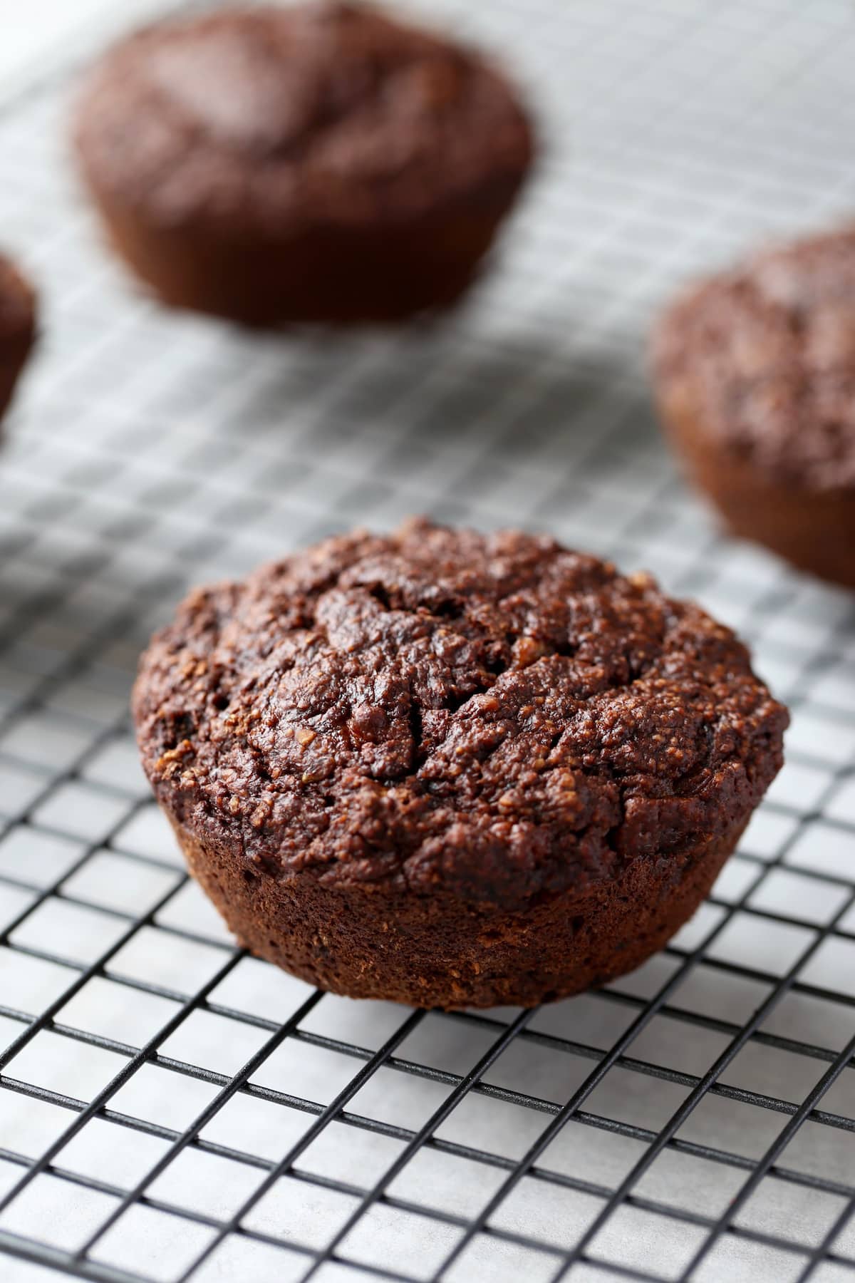 jumbo chocolate muffins cooling on a wire rack