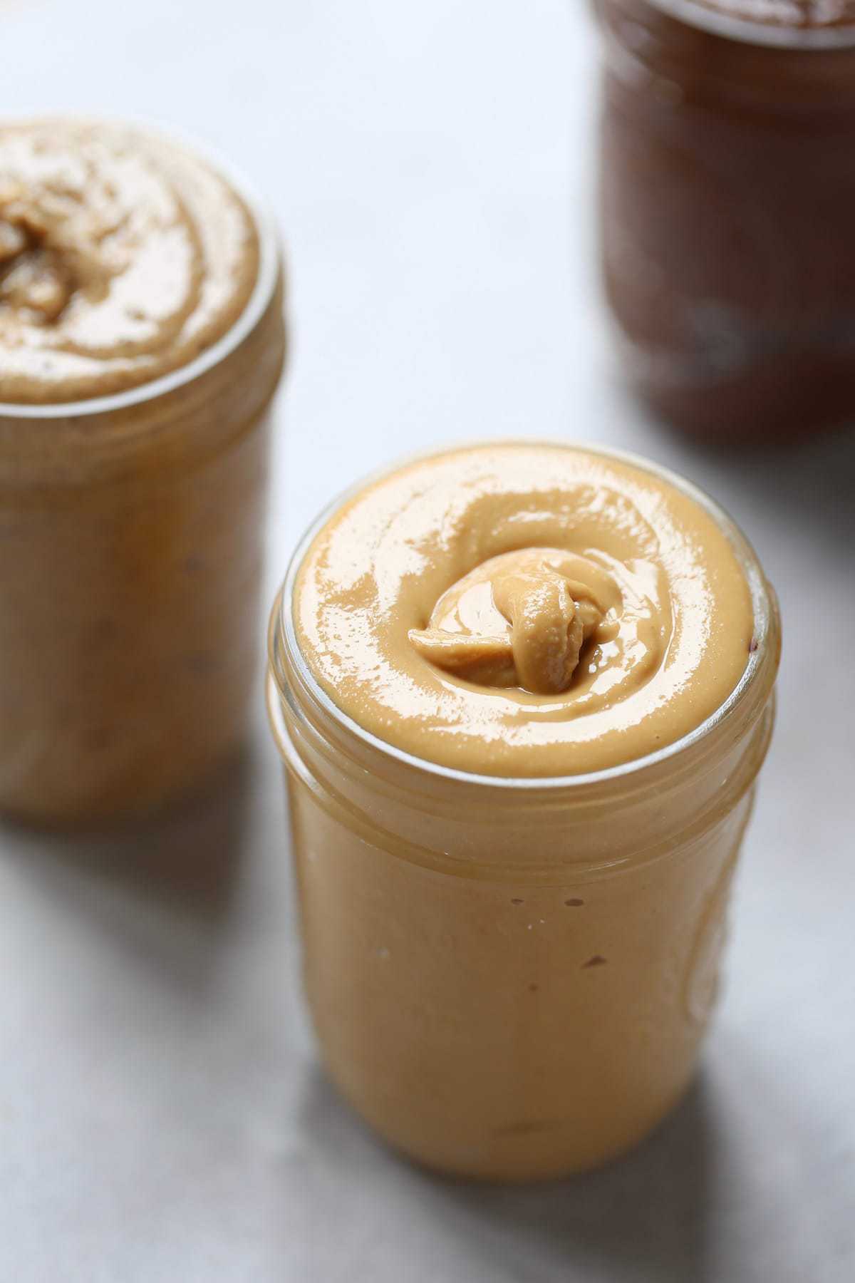 drippy homemade peanut butter in a mason jar