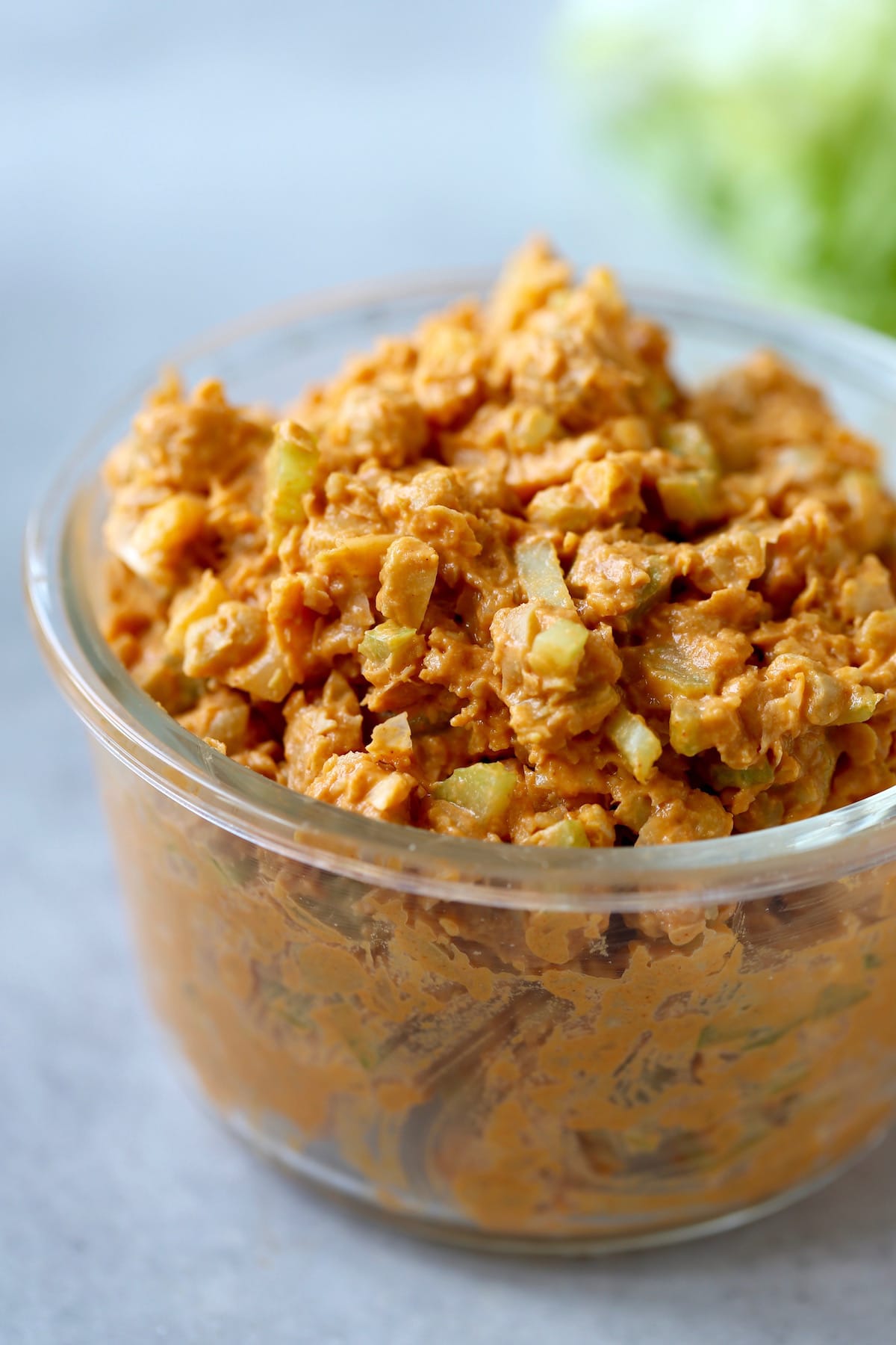 Buffalo chickpea salad in a glass storage container. 