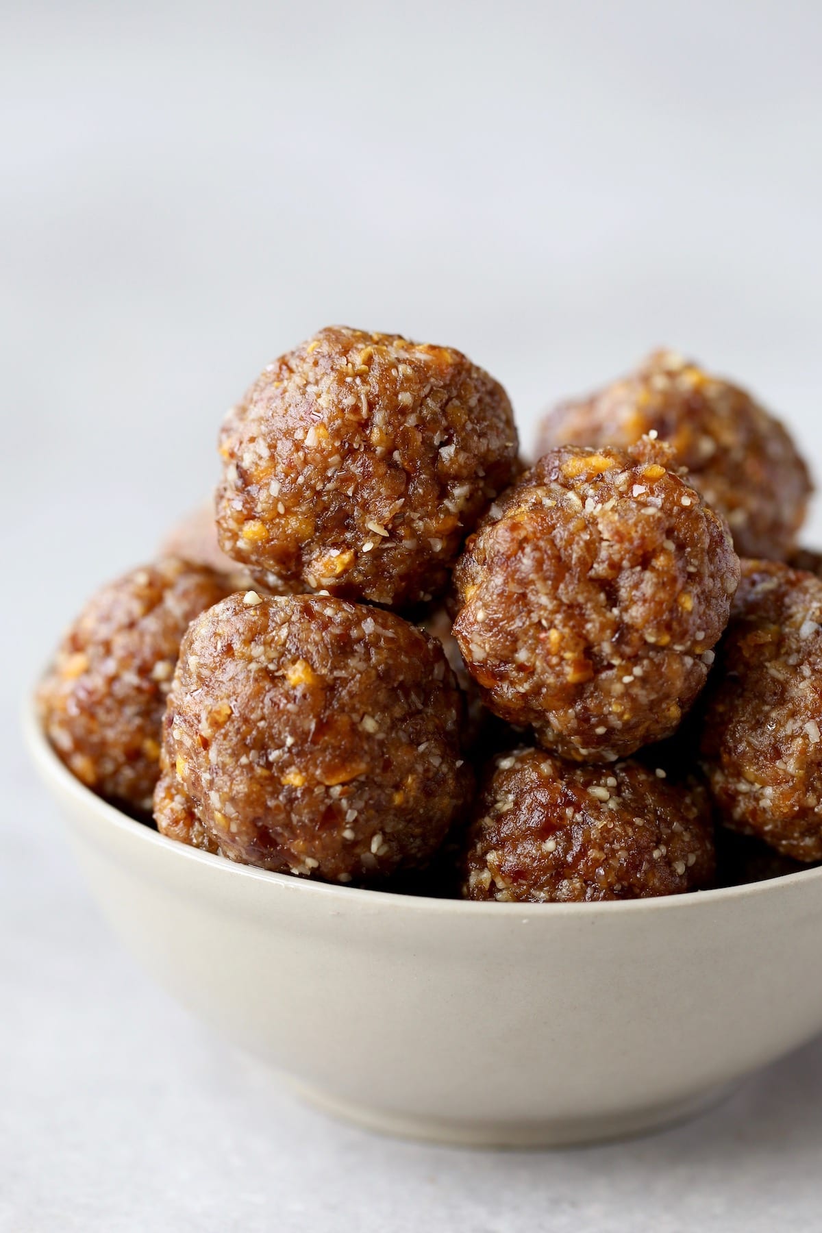 mango coconut energy bites piled high in a bowl