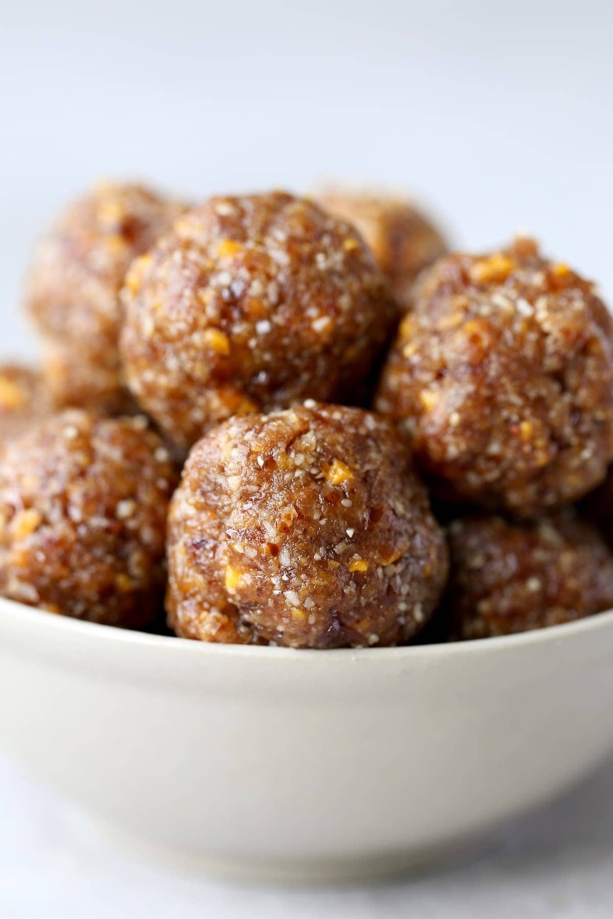 mango coconut energy bites piled high in a bowl