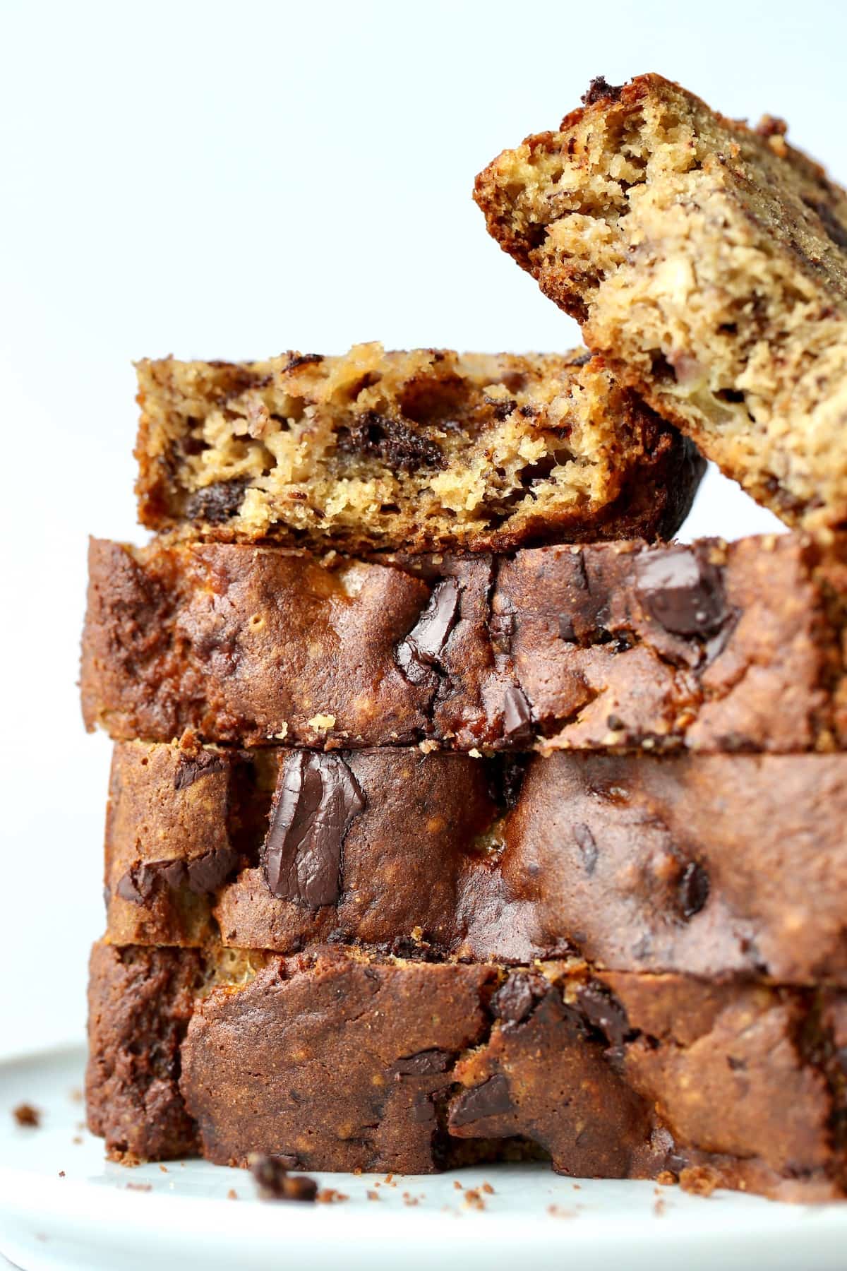 thick slices of chocolate chunk banana bread stacked on a plate