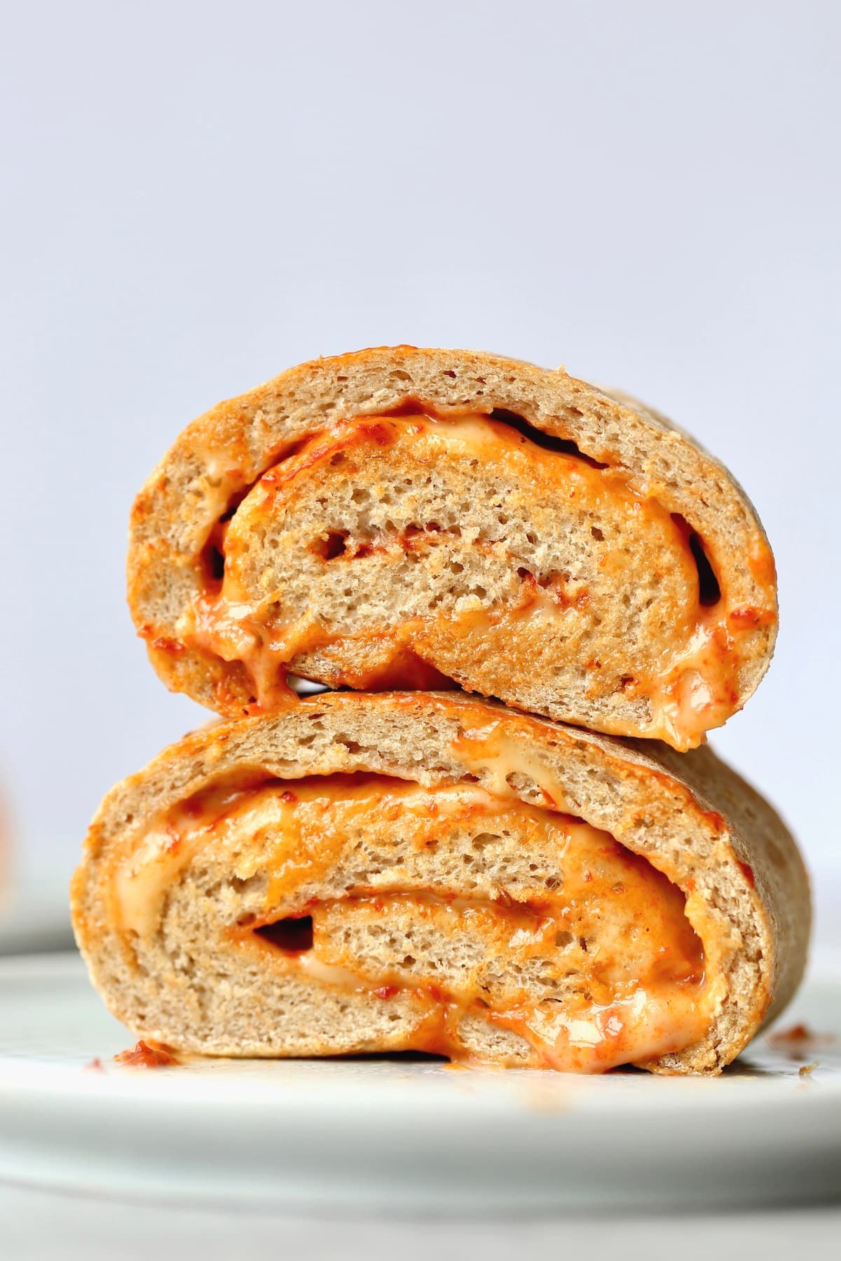 two sliced of cheesy pizza bread stacked on a plate