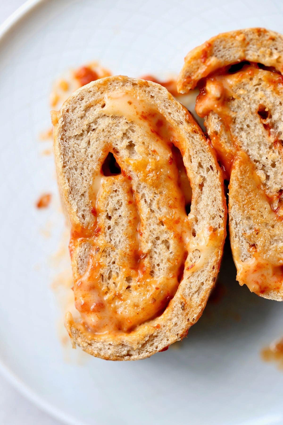 A cheesy slice of pizza bread on a plate