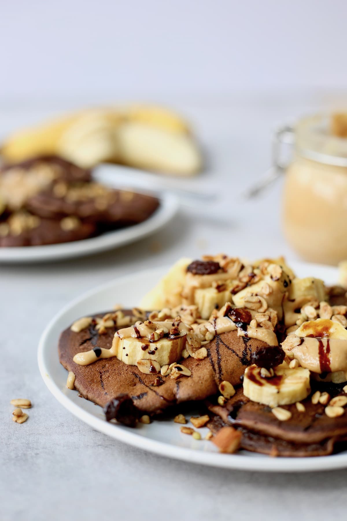 plates of chocolate pancakes loaded with lots of toppings