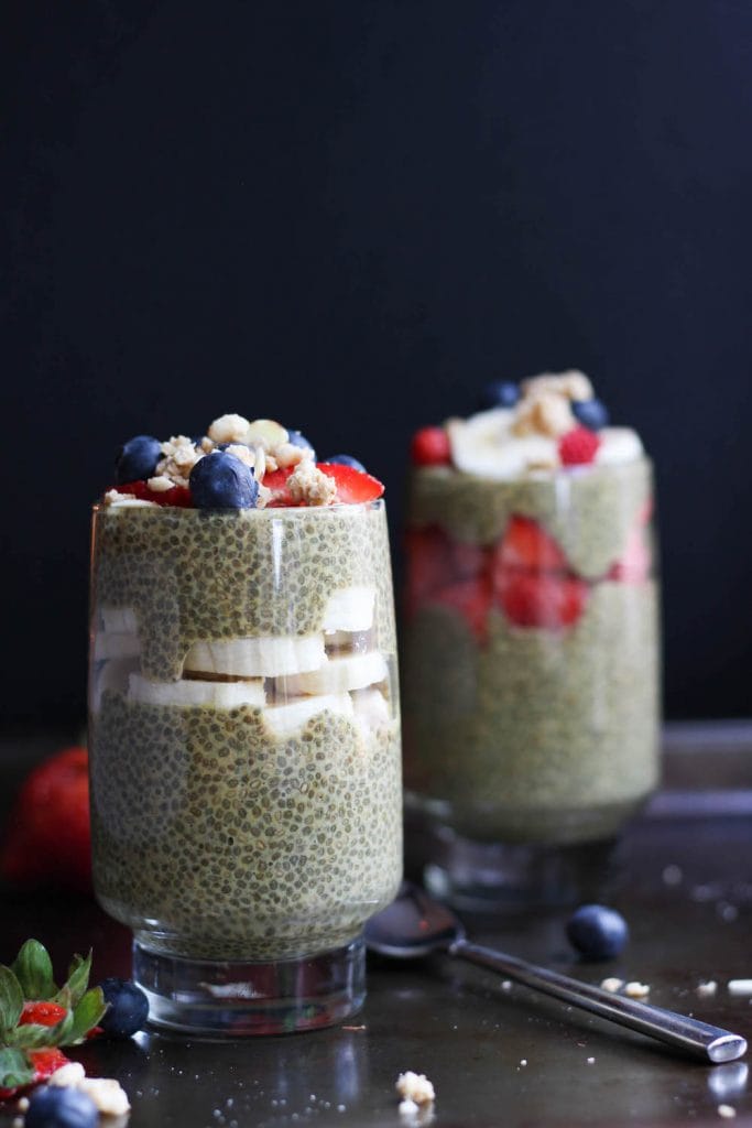 golden milk chia seed pudding layered in a jar with fruit and granola