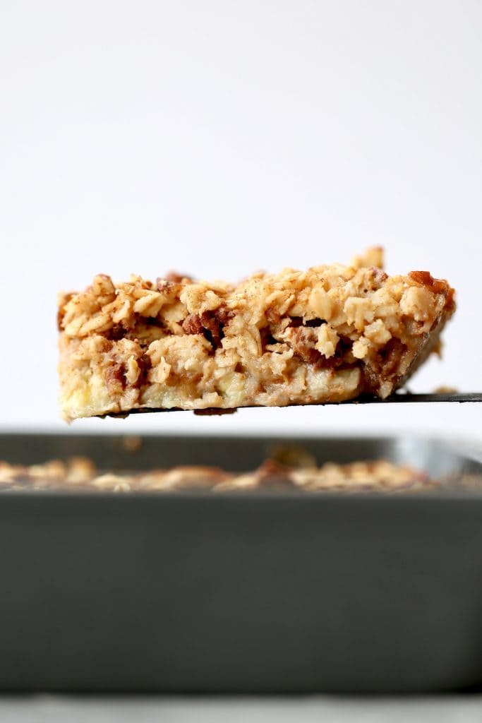 a thick slice of maple pecan baked oatmeal on a spatula