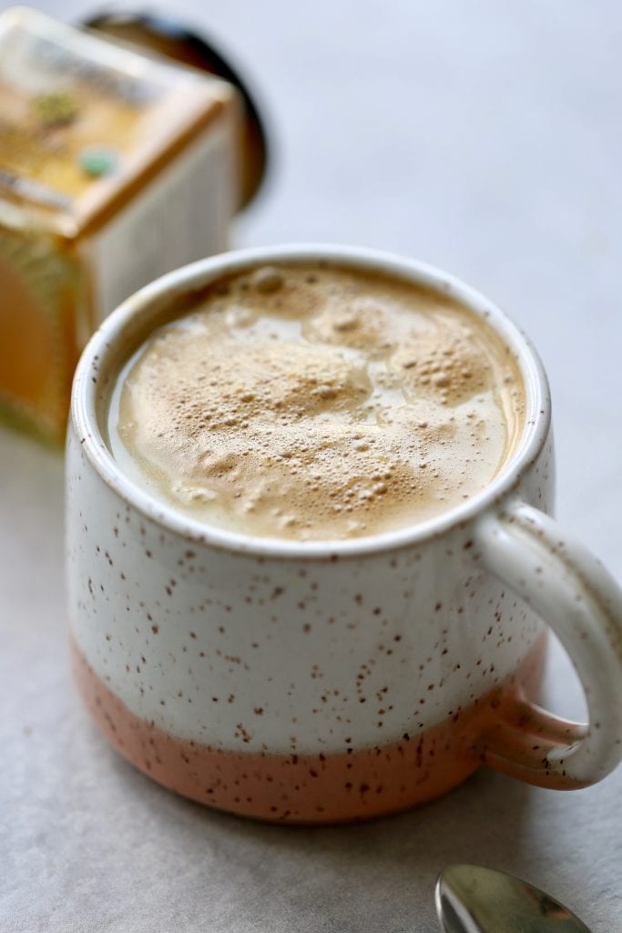 frothy turmeric hot chocolate in a mug
