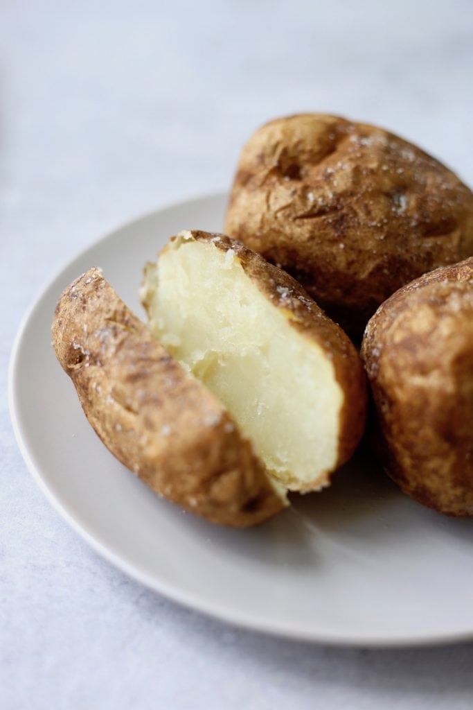 a baked potato cut vertically on a plate