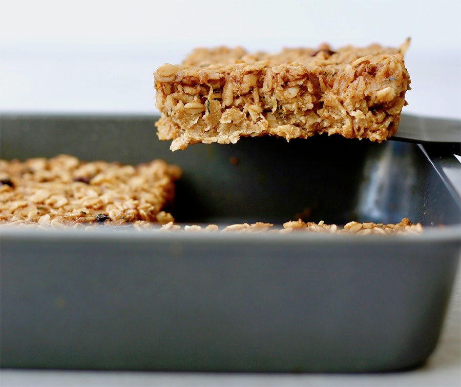 Baked oatmeal slice being pulled out the pan