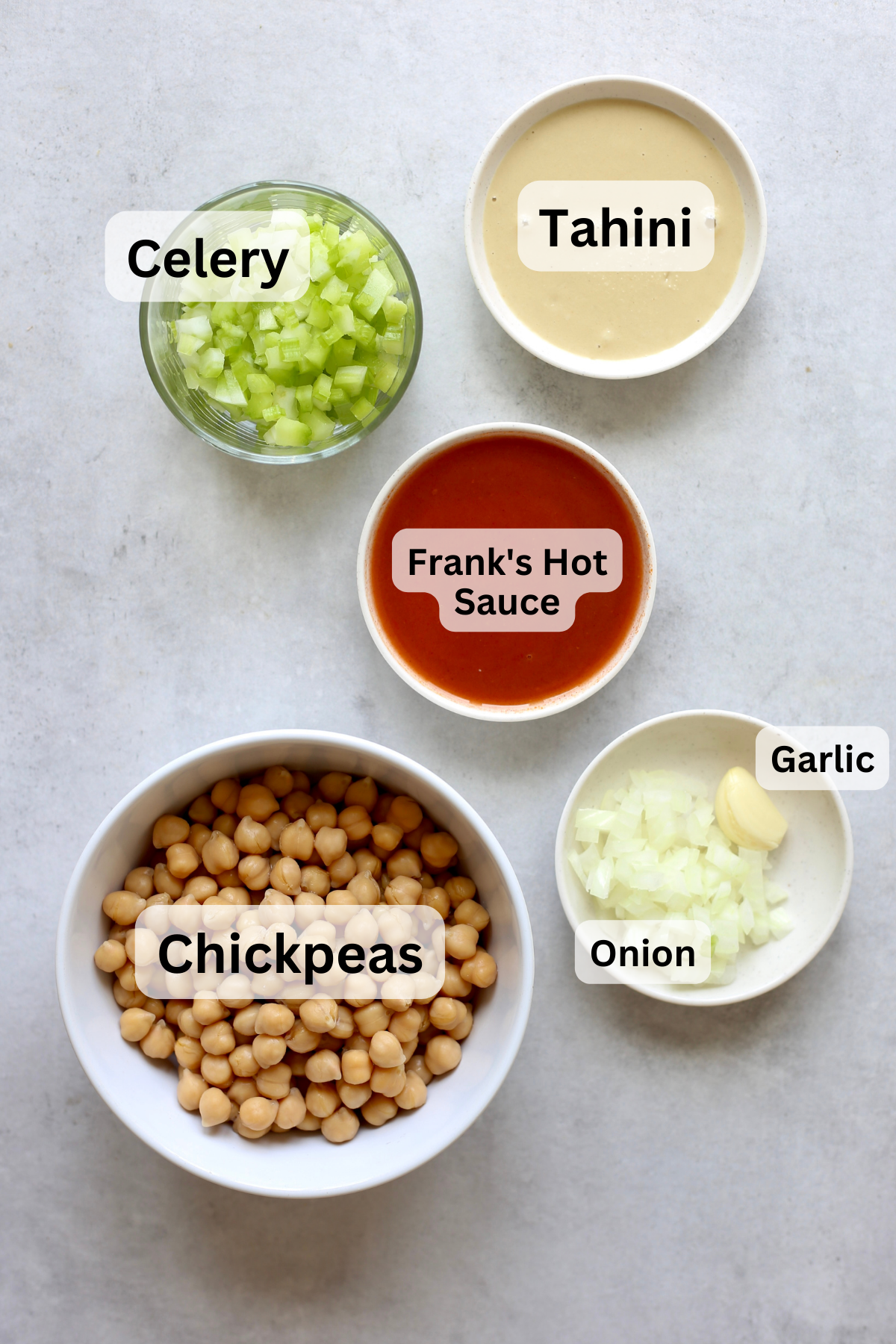 All of the ingredients for buffalo chickpea salad measured out into bowls.