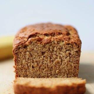 the BEST vegan banana bread being cut up on a cutting board