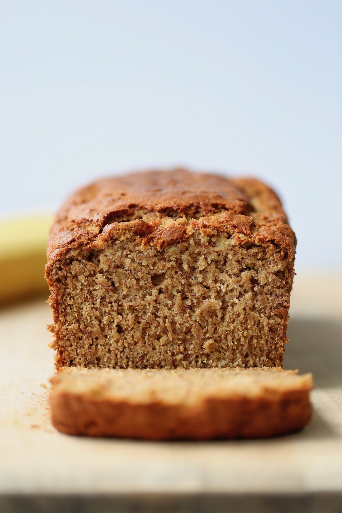 the BEST vegan banana bread being cut up on a cutting board