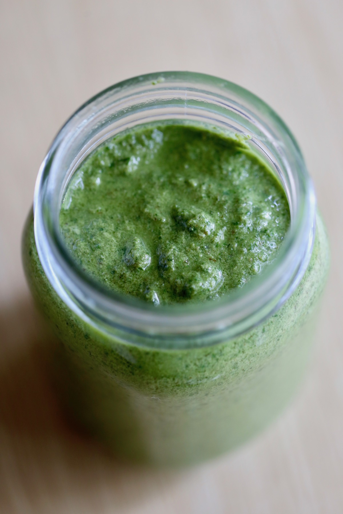 a mason jar full of homemade vegan pesto sauce