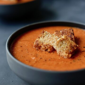 creamy tomato zucchini soup topped with grilled cheese croutons