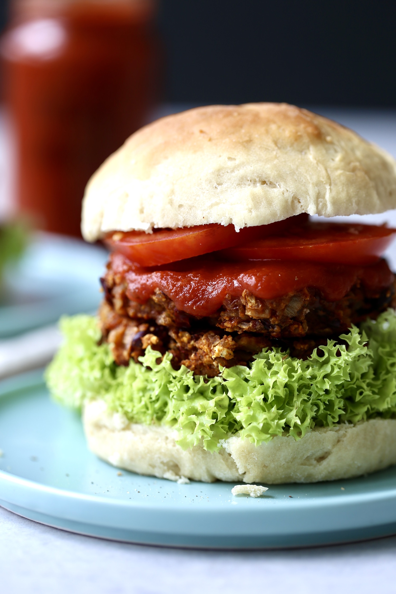 a veggie burger loaded with veggies and extra bbq sauce