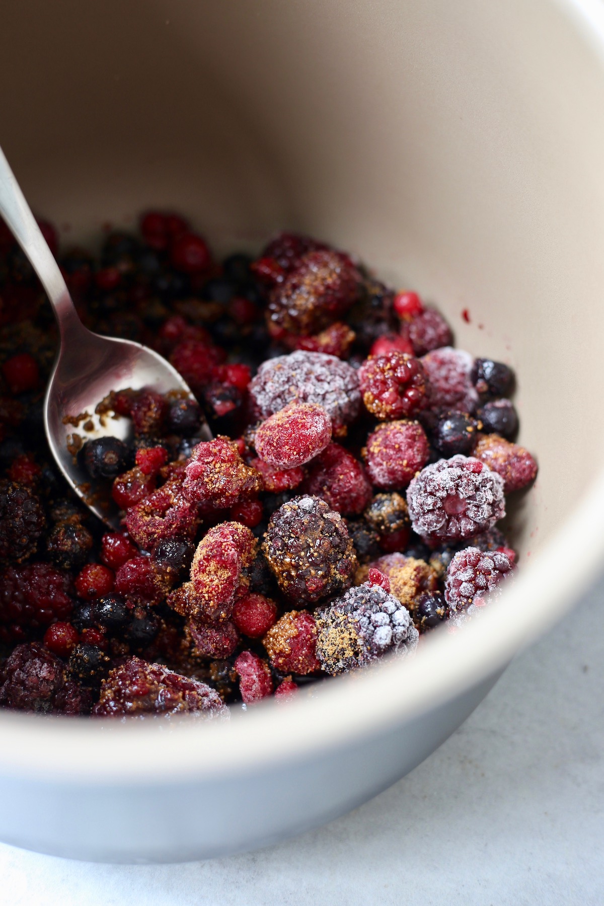 frozen berries, coconut sugar and water in the bowl of a pressure cooker