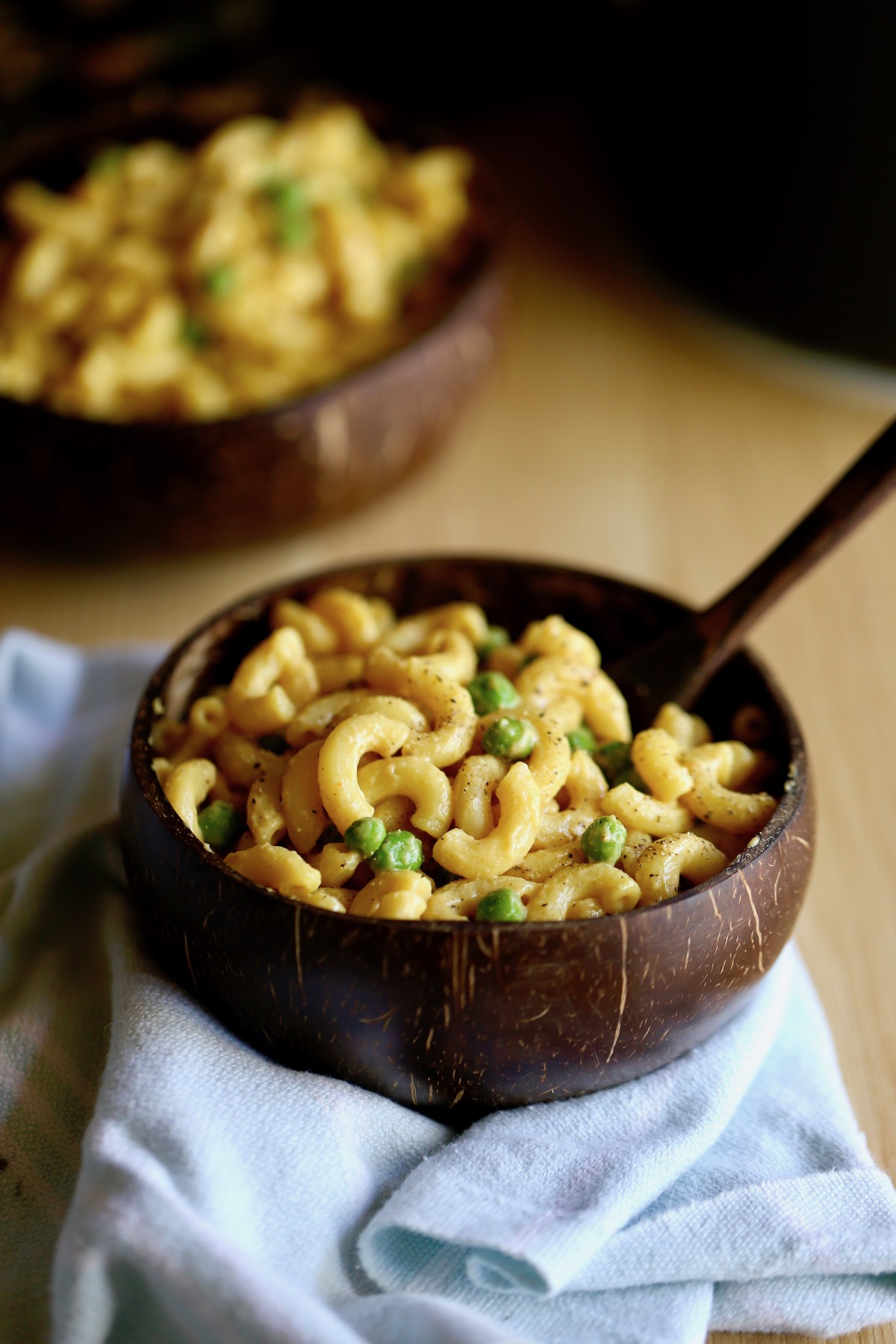 a bowl loaded with vegan mac and cheese and peas