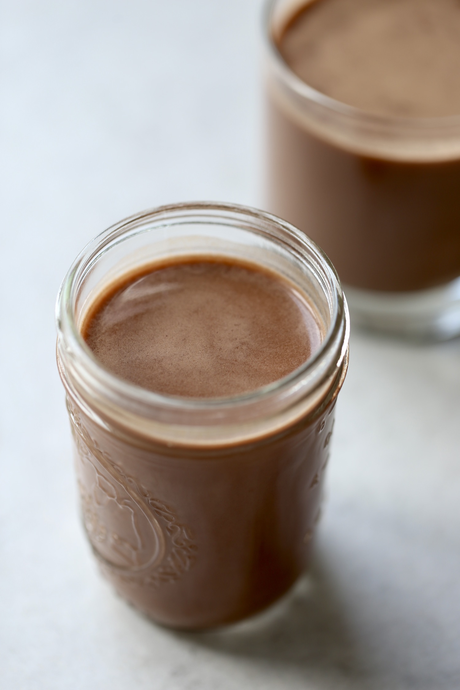 a glass of chocolate oat milk