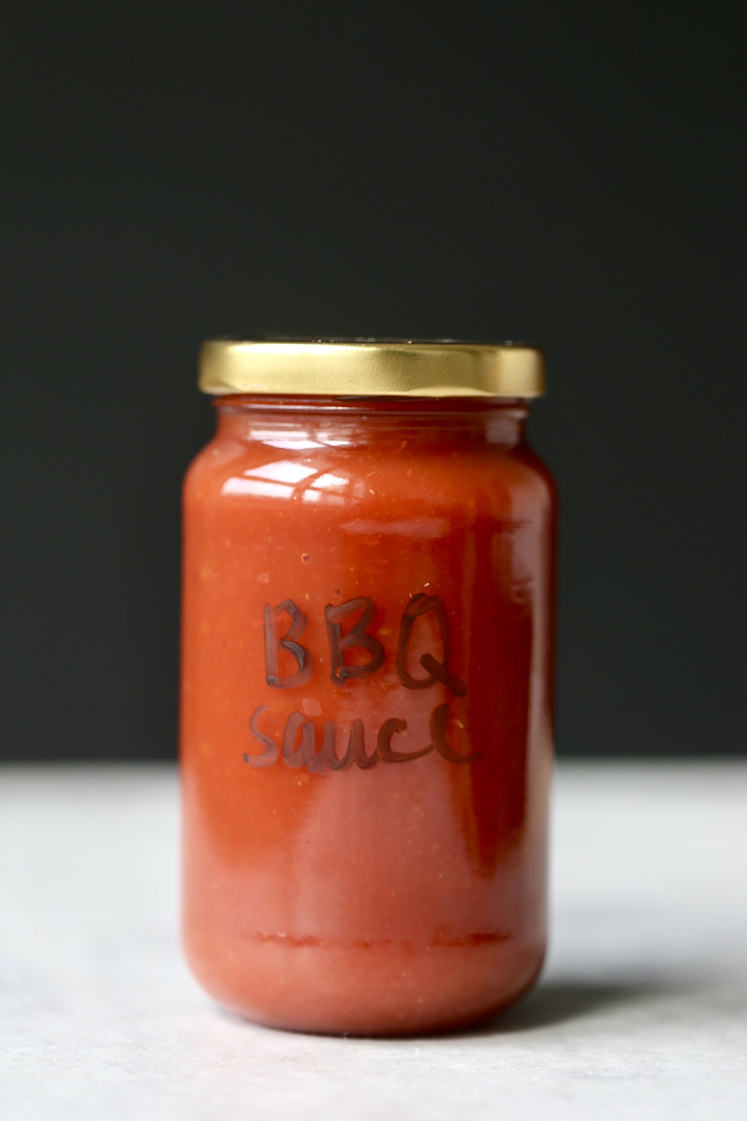 a jar with vegan bbq sauce in it