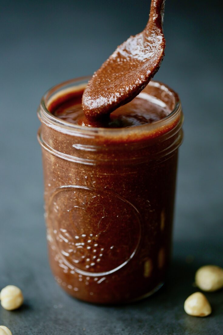 spoon dipped into homemade nutella jar