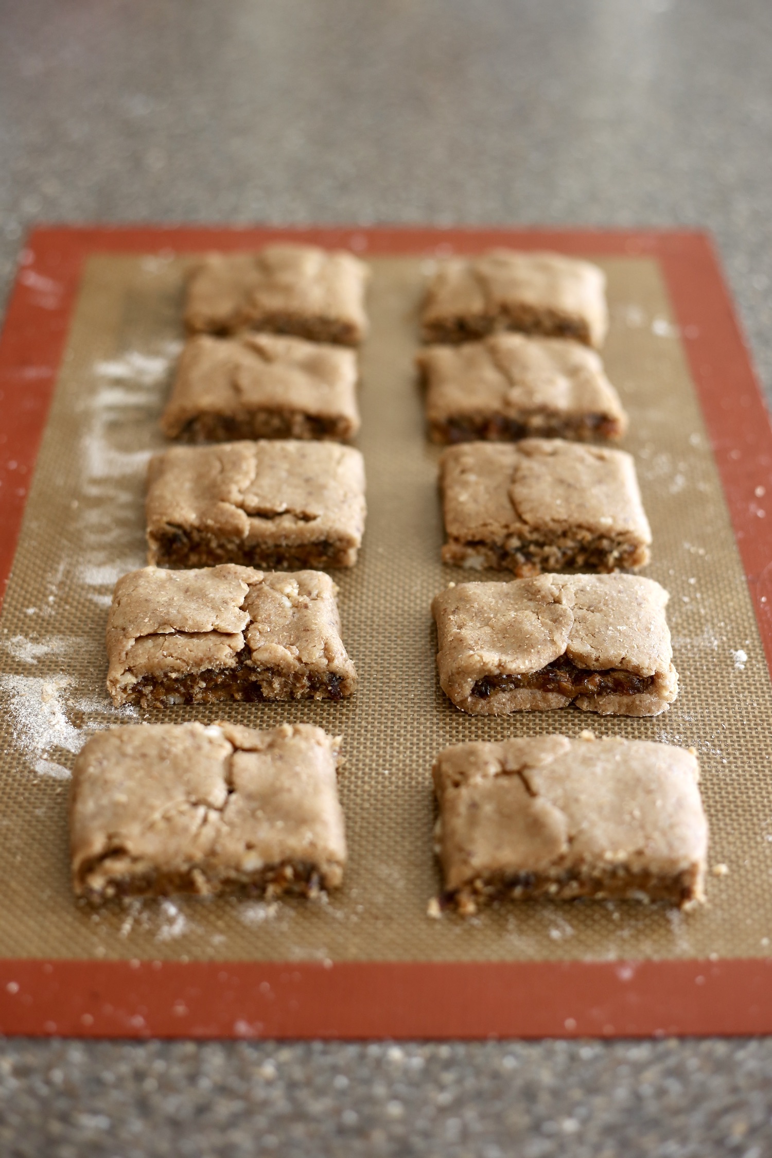 homemade fig newtons on a silicone baking mat before baking