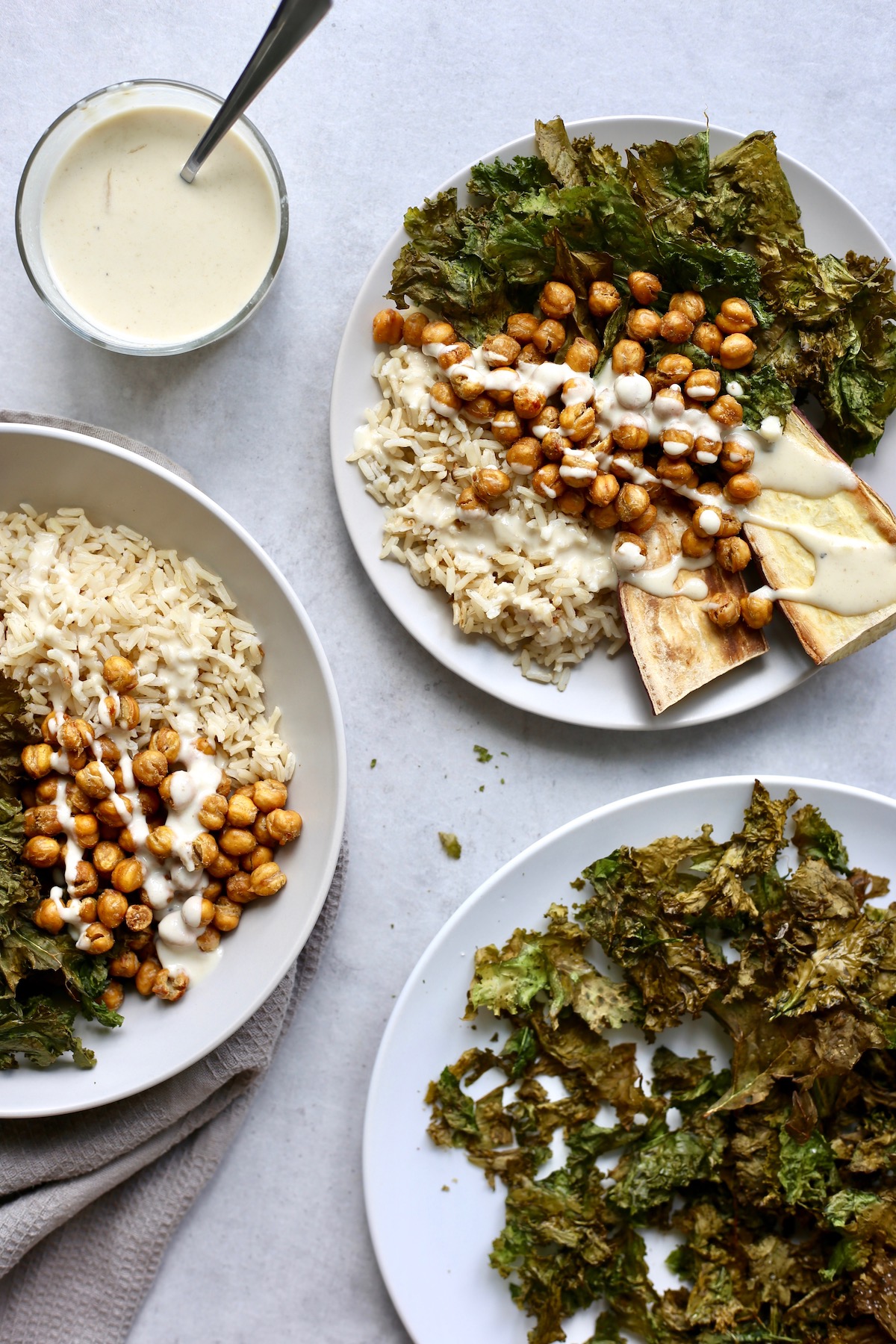 a buddha bowl with brown rice, roasted chickpeas and lemon tahini dressing