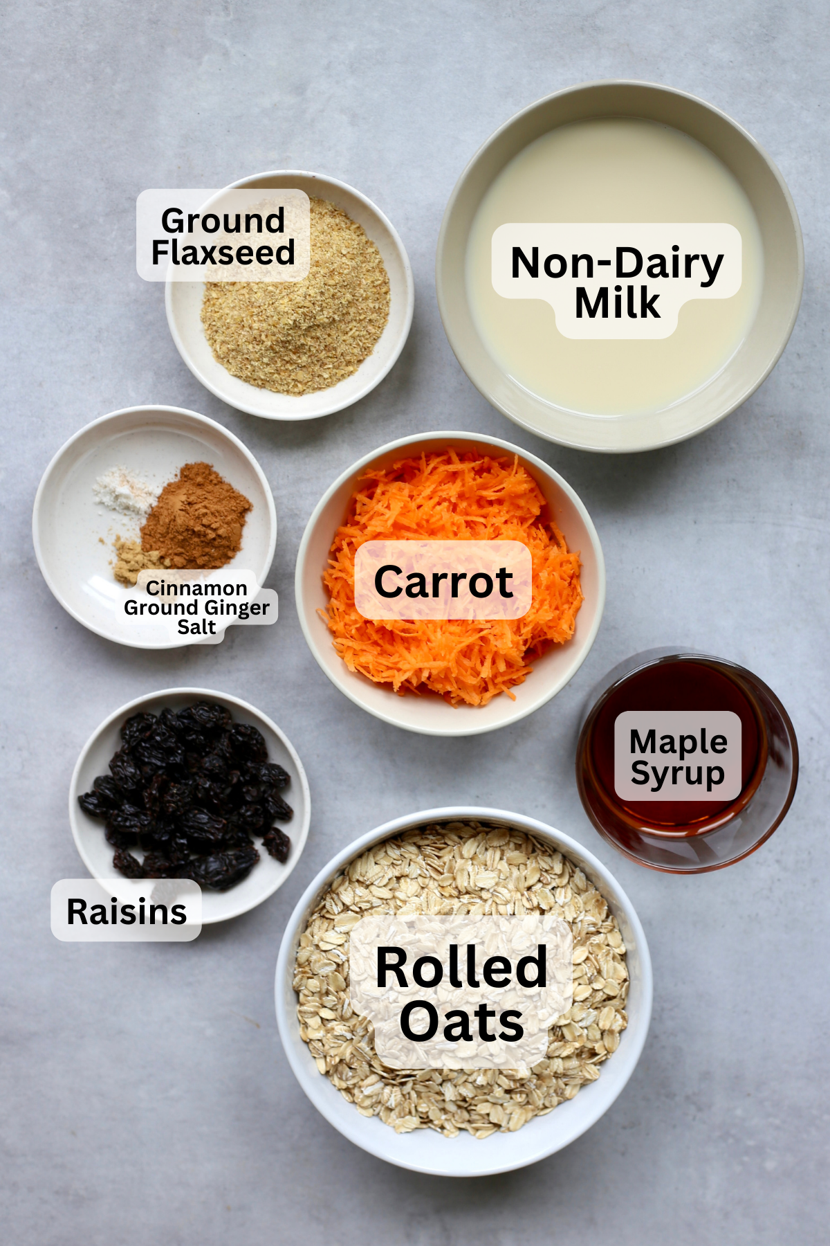 An overhead shot of the ingredients for carrot cake baked oatmeal measured out into bowls. 