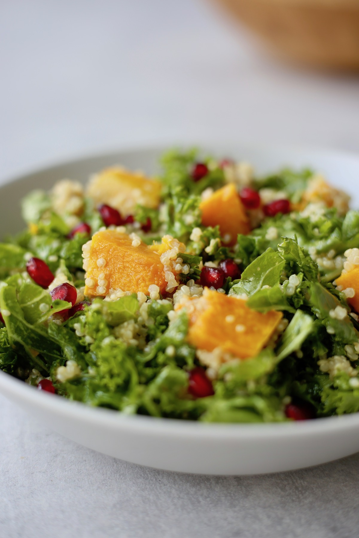 Vibrant butternut squash on top of massage kale