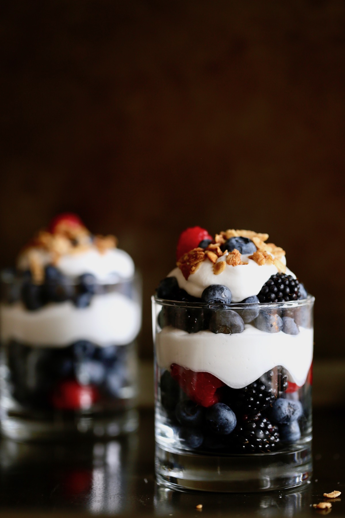 berries, homemade whipped cream and granola layered to create vegan berries and cream parfaits