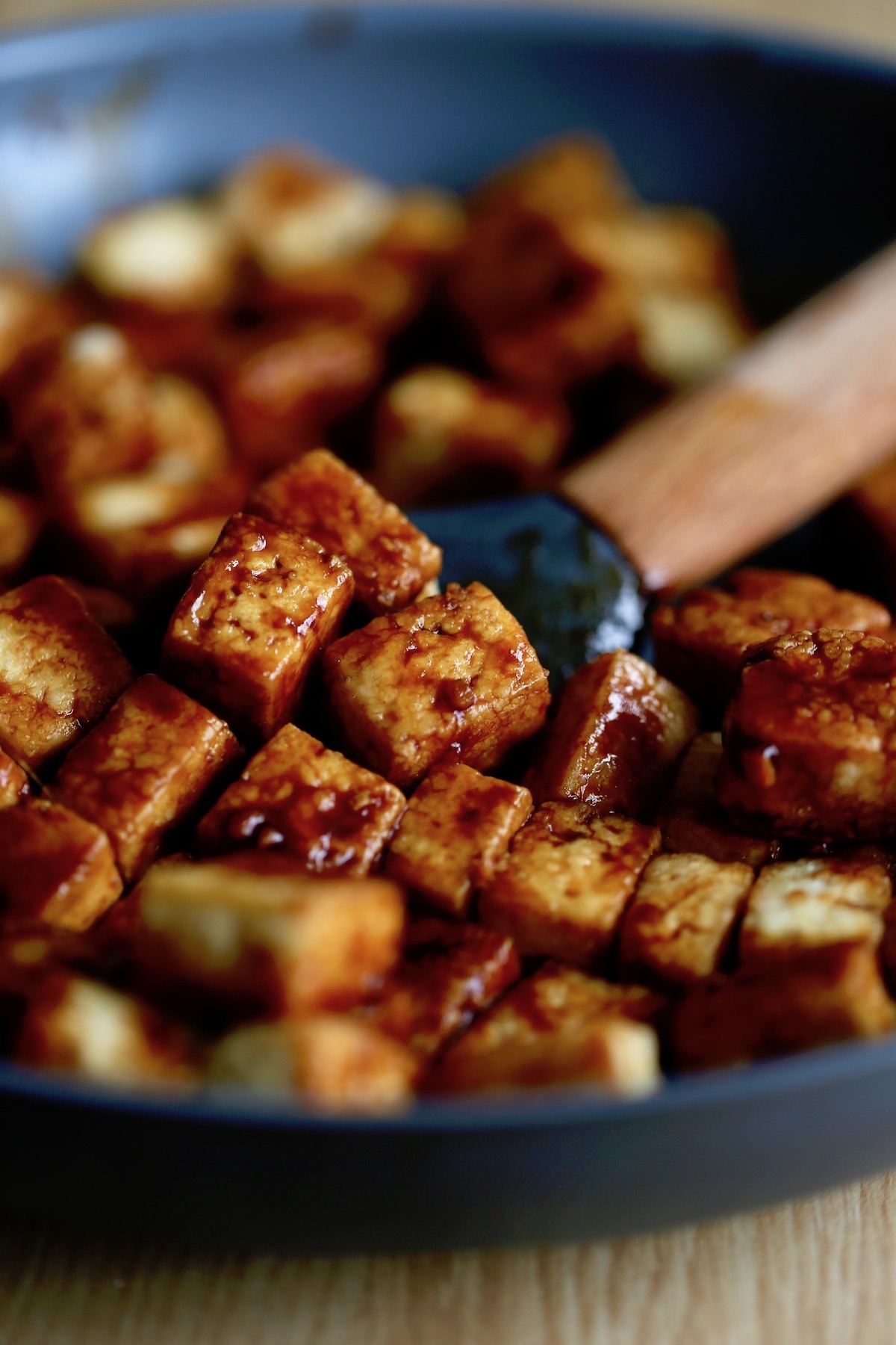 sweet and sour tofu being stirred in a pan