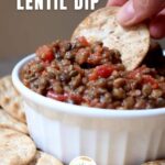 cracker being dipped into lentil dip