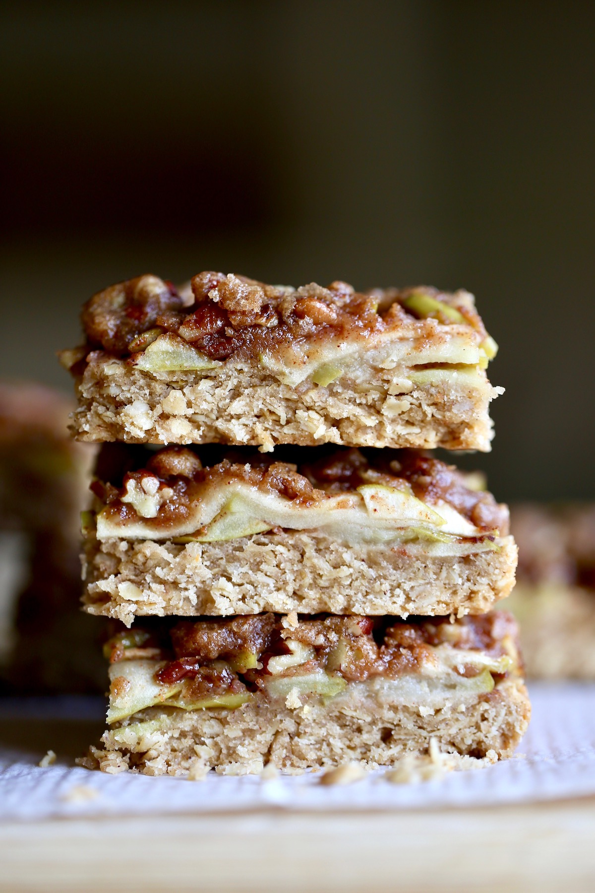 vegan apple pie oatmeal bars stacked on top of each other
