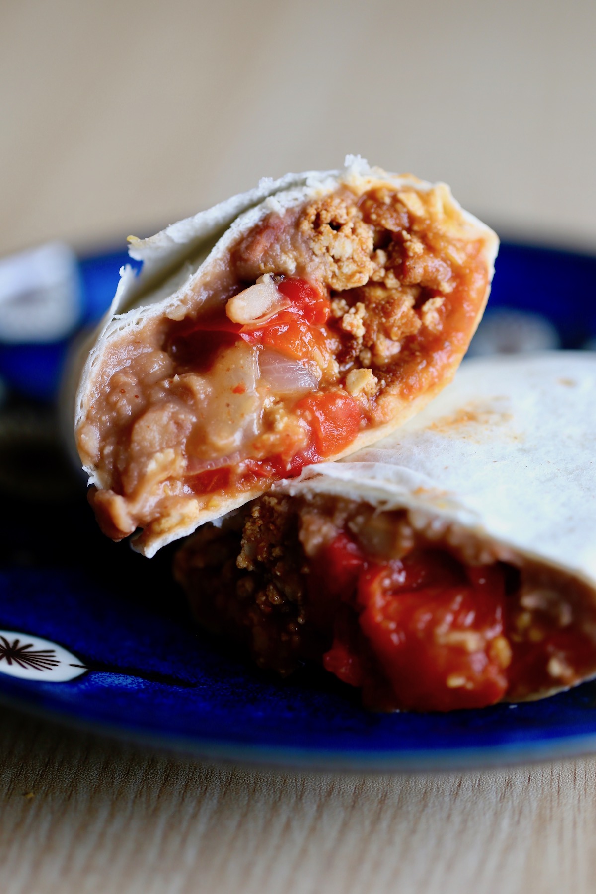 a vegan breakfast burrito cut in half