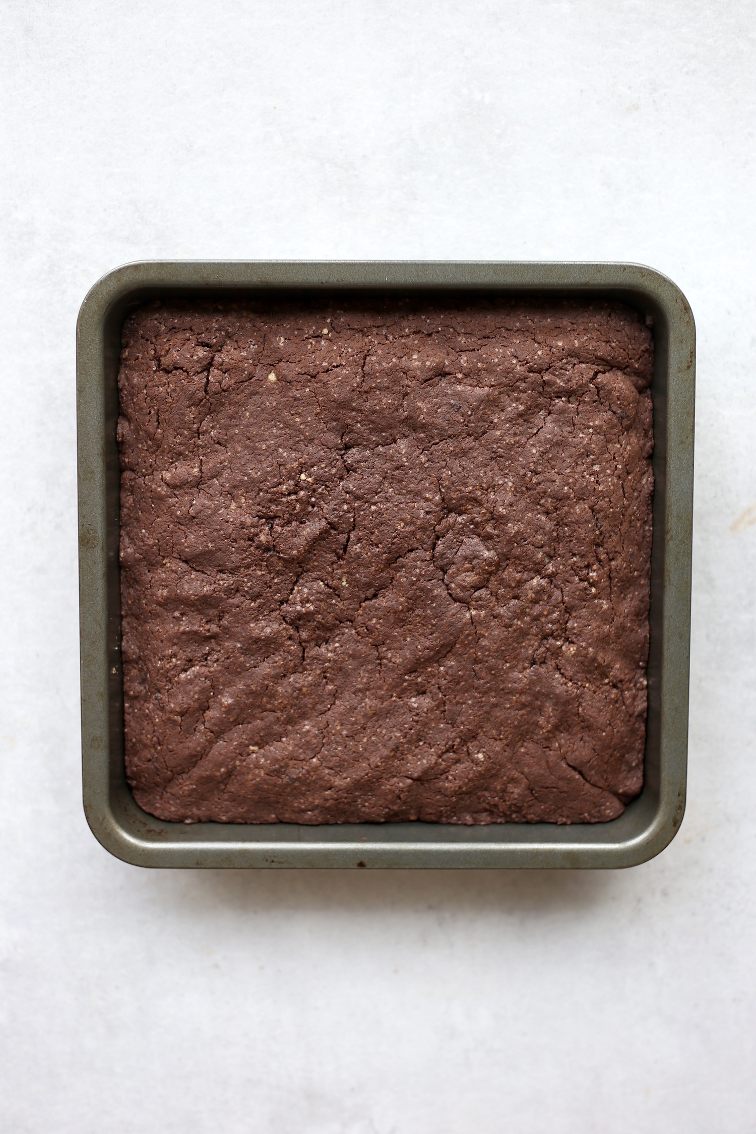 An overhead shot of vegan brownies in an 8x8 inch metal baking dish. 