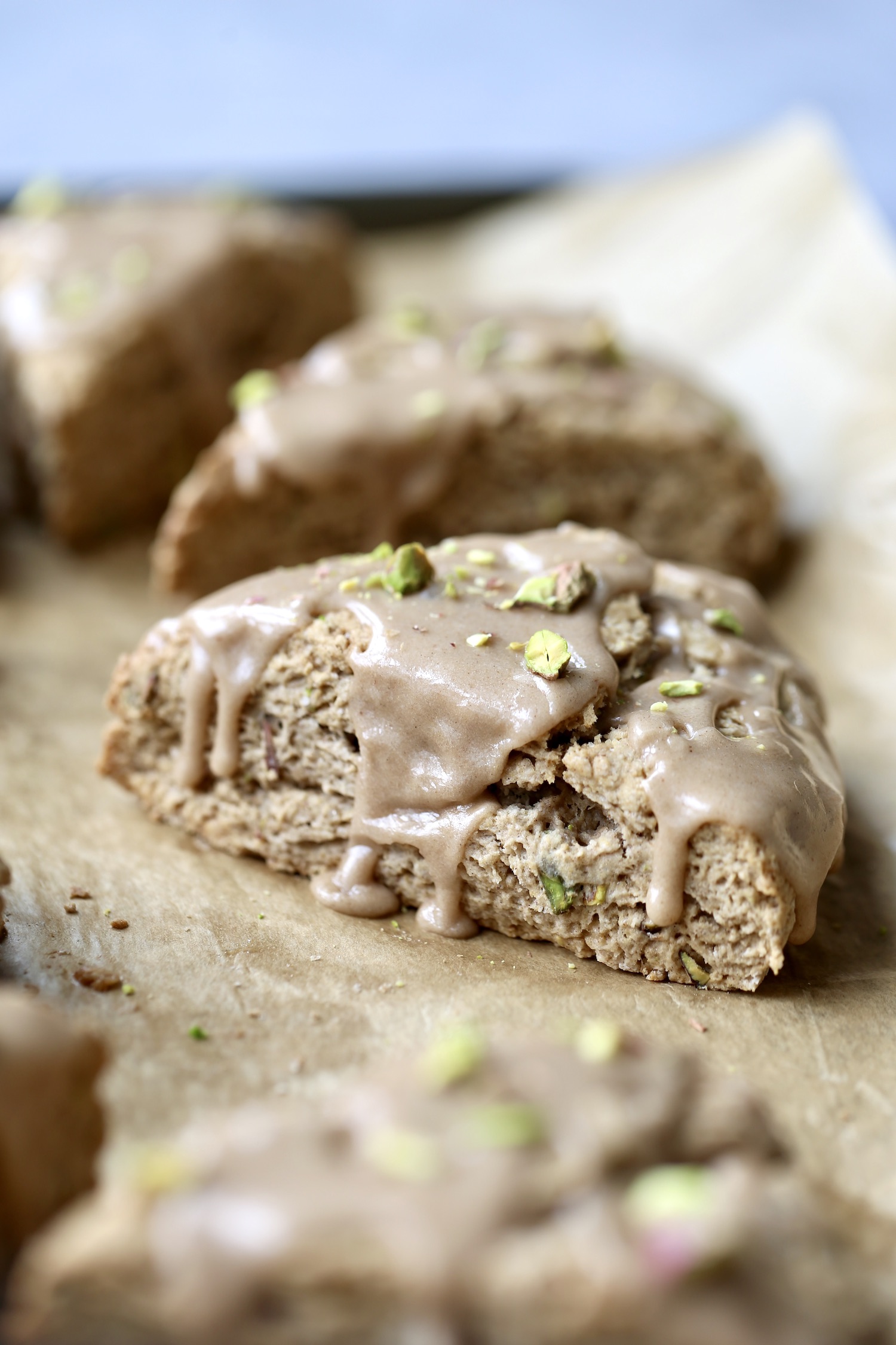 vegan cardamom pistachio scones glazed with a chai spiced icing