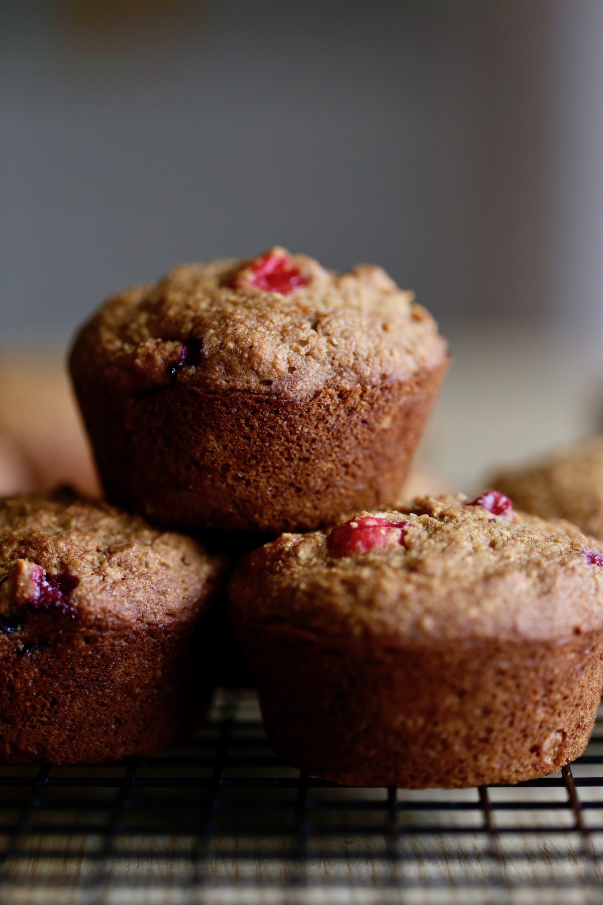 cranberry orange muffins cooling on a wire rack