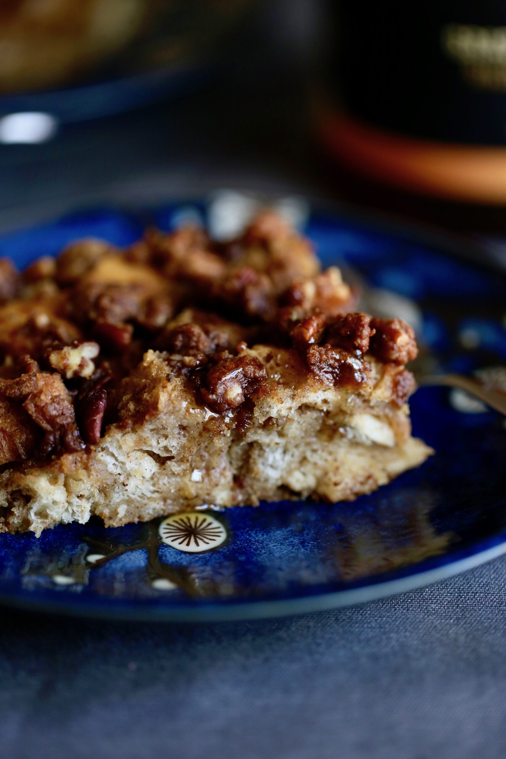 vegan french toast casserole drizzled with maple syrup on a plate